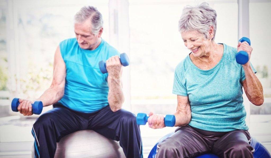 elderly couple exercising with weights