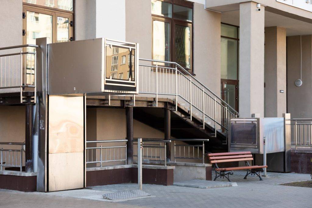 an outside platform lift going up stairs